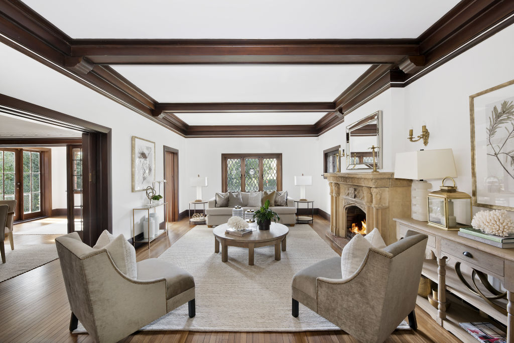 Brass wall sconces, box-beam ceilings and the few fireplaces complement the historic feel of the home. Photo: Supplied