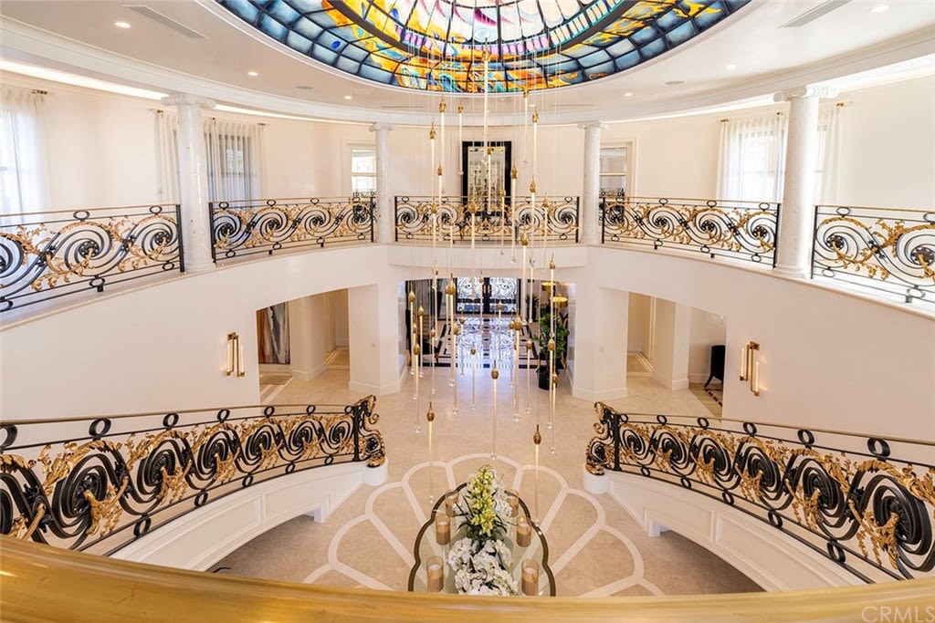 The grand entry foyer features a double staircase and has a colourful glass dome at the centre of the ceiling.