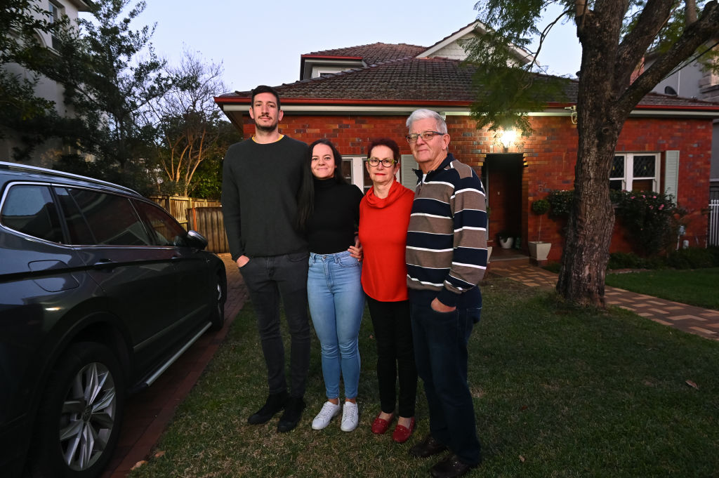 Claire Walker with partner Hugh and her parents outside of their family home. Photo: Steven Saphore
