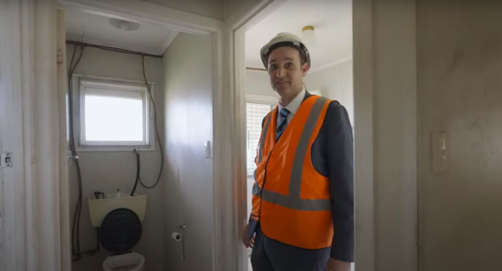 Selling agent Brad Shipway inspects the bathroom and shows the DIY plumbing.