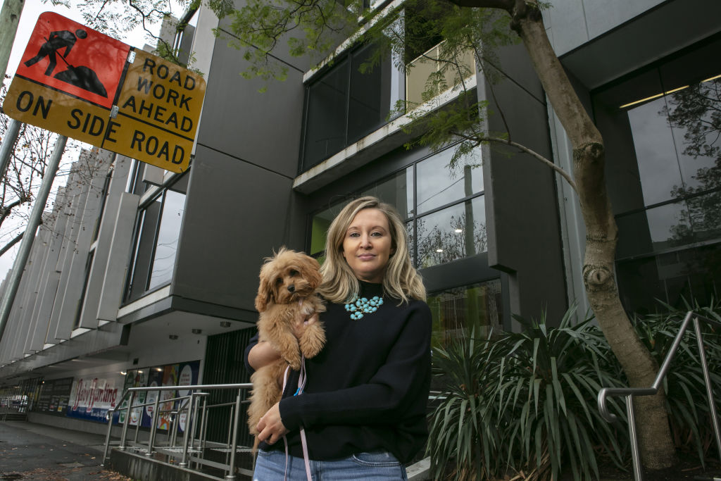 Zoe Foster, pictured with her dog Luna, is calling on the Victorian Government to appoint an independent building commissioner to assess defects in apartment buildings. Photo: Stephen McKenzie