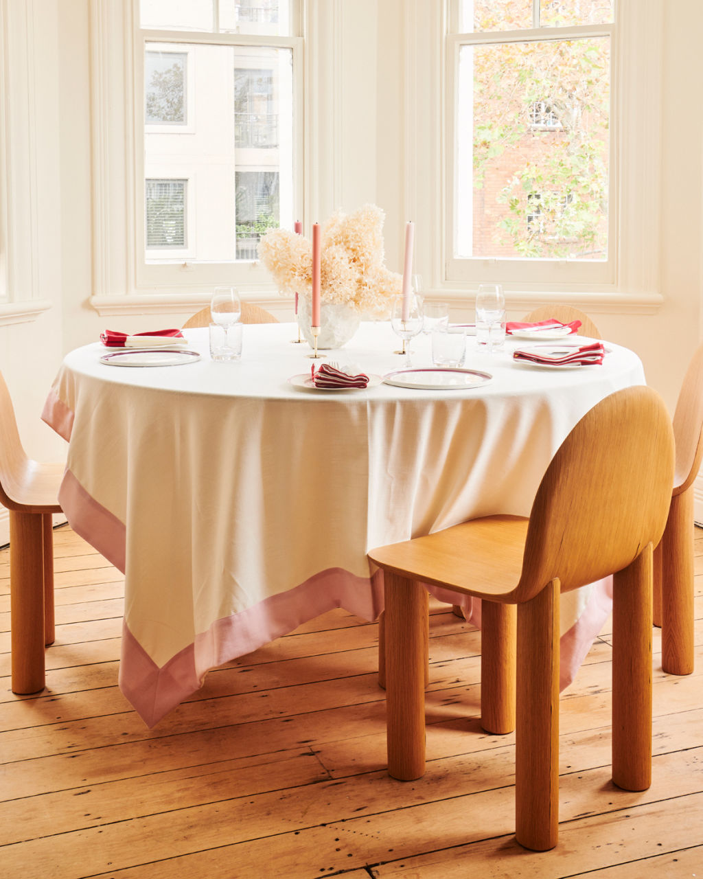 Set the scene with coloured candles. Dinner table setting with linen and plates from In The Roundhouse. Photo: SEVAK BABAKHANI