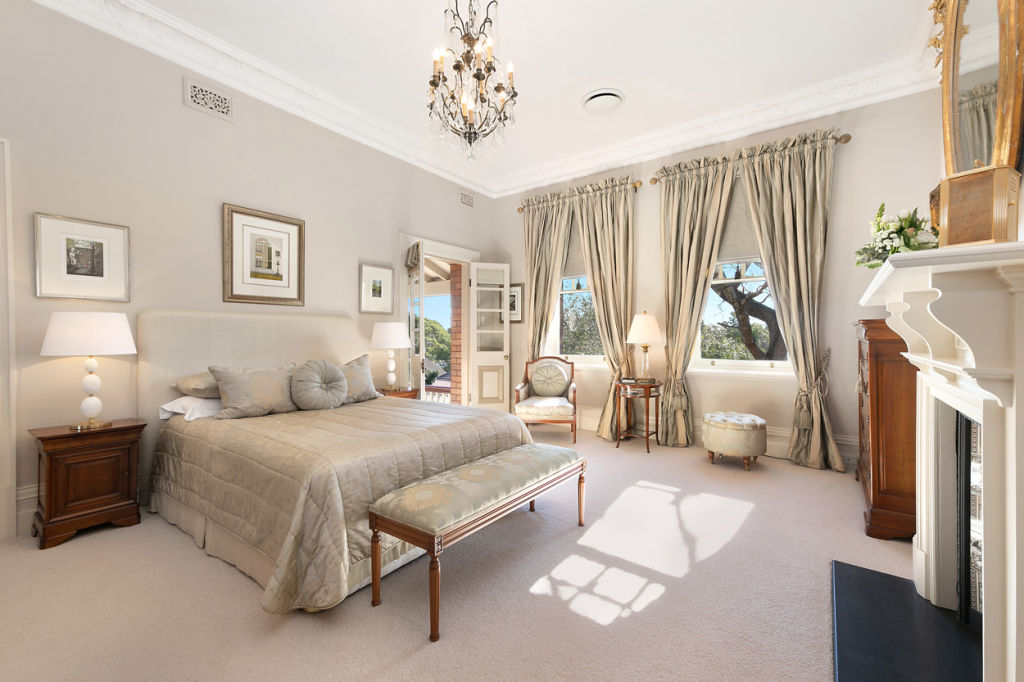 This bedroom features a fully functioning marble fireplace and chandelier. Photo: Supplied