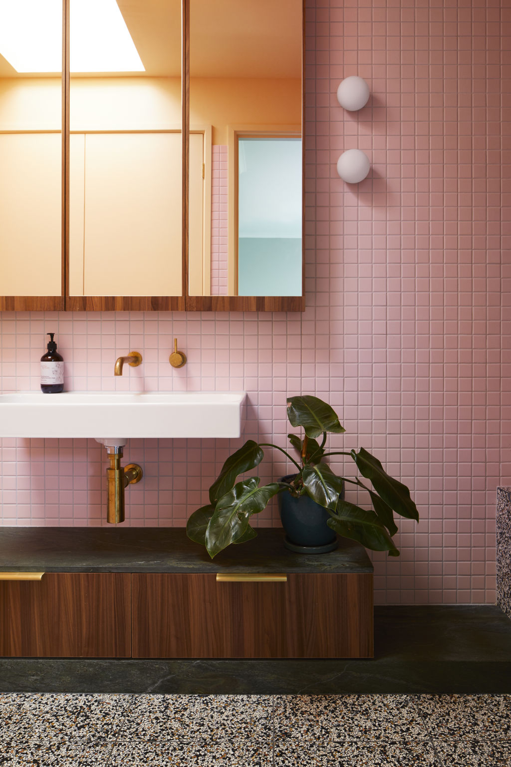 The family bathroom upstairs boasts pops of pink, orange and terrazzo. Photo: Armelle Habib