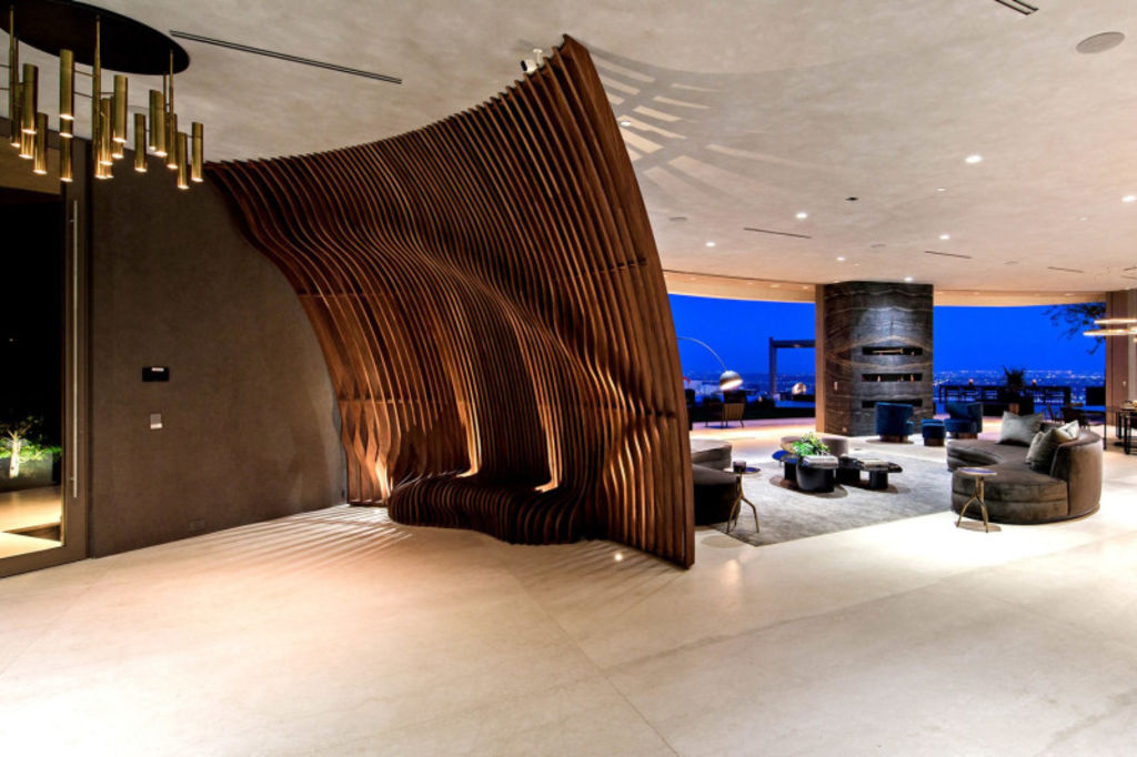 Guests are greeted by a floor-to-ceiling walnut sculpture designed by master Japanese carpenter Toshi Kawabata. Photo: Dirt/Unlimited Style Photography