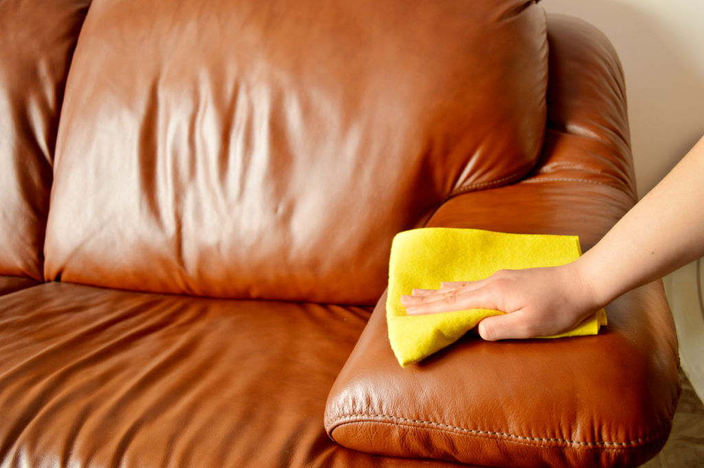 Use warm water and dish soap to remove stains from leather furniture. Photo: iStock