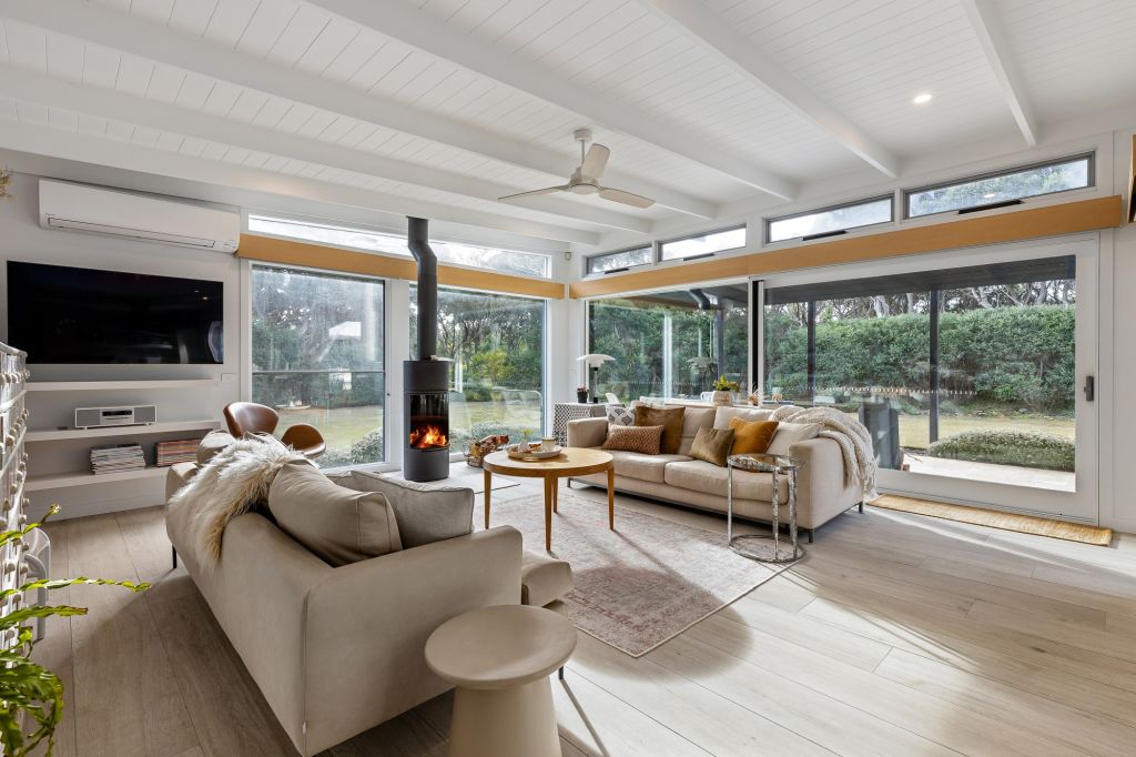 One of three living spaces, this one featuring the open fire sits open-plan with the kitchen. Photo: Ray White