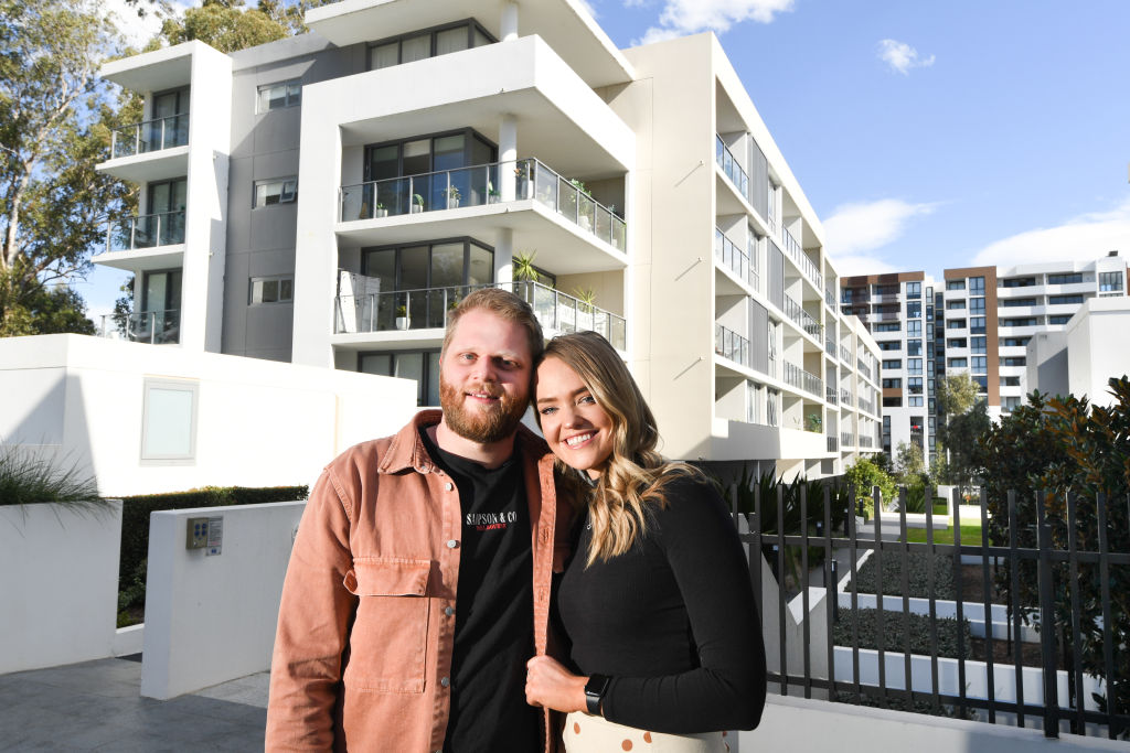 Georgia Eccles and partner Ryan Peoples outside their newly purchased apartment. The couple gave up on finding a house after prices skyrocketed completely out of their reach. Photo: Peter Rae