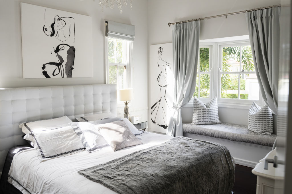 In the bedroom, textured white linen elegantly drapes the master bed while silver curtains add a shimmer of romance. Photo: Marc Pricop