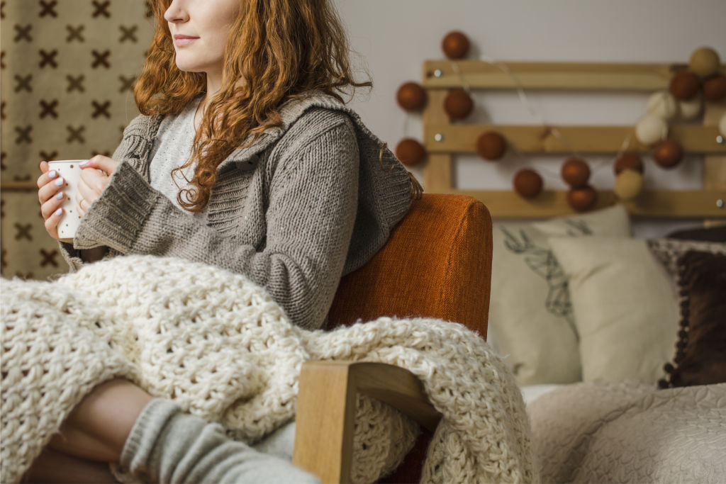 Dress warmly in winter instead of reaching for the heater, and bank the energy savings. Photo: iStock