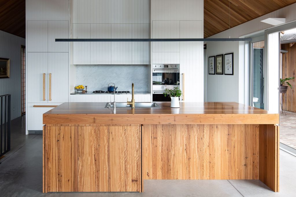 A combination of blackbutt veneer with a butcher's block-type surface, the timber island is the main element of the kitchen area. Photo: Simon Whitbread