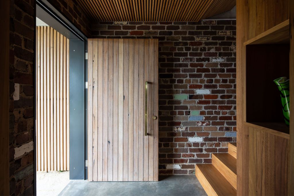 Compressed and materially heavy, the entry invites a journey upstairs into the light and water views. Wagstaffe House. Photo: Simon Whitbread