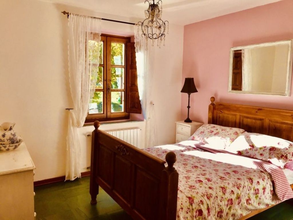 One of four bedrooms in the property. Photo: Win Houses in Italy