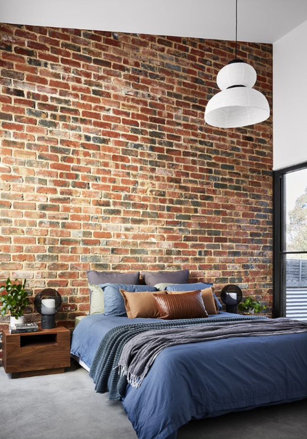 Pre-loved bricks make the main bedroom suite in a new build feel settled. Photo: Tess Kelly