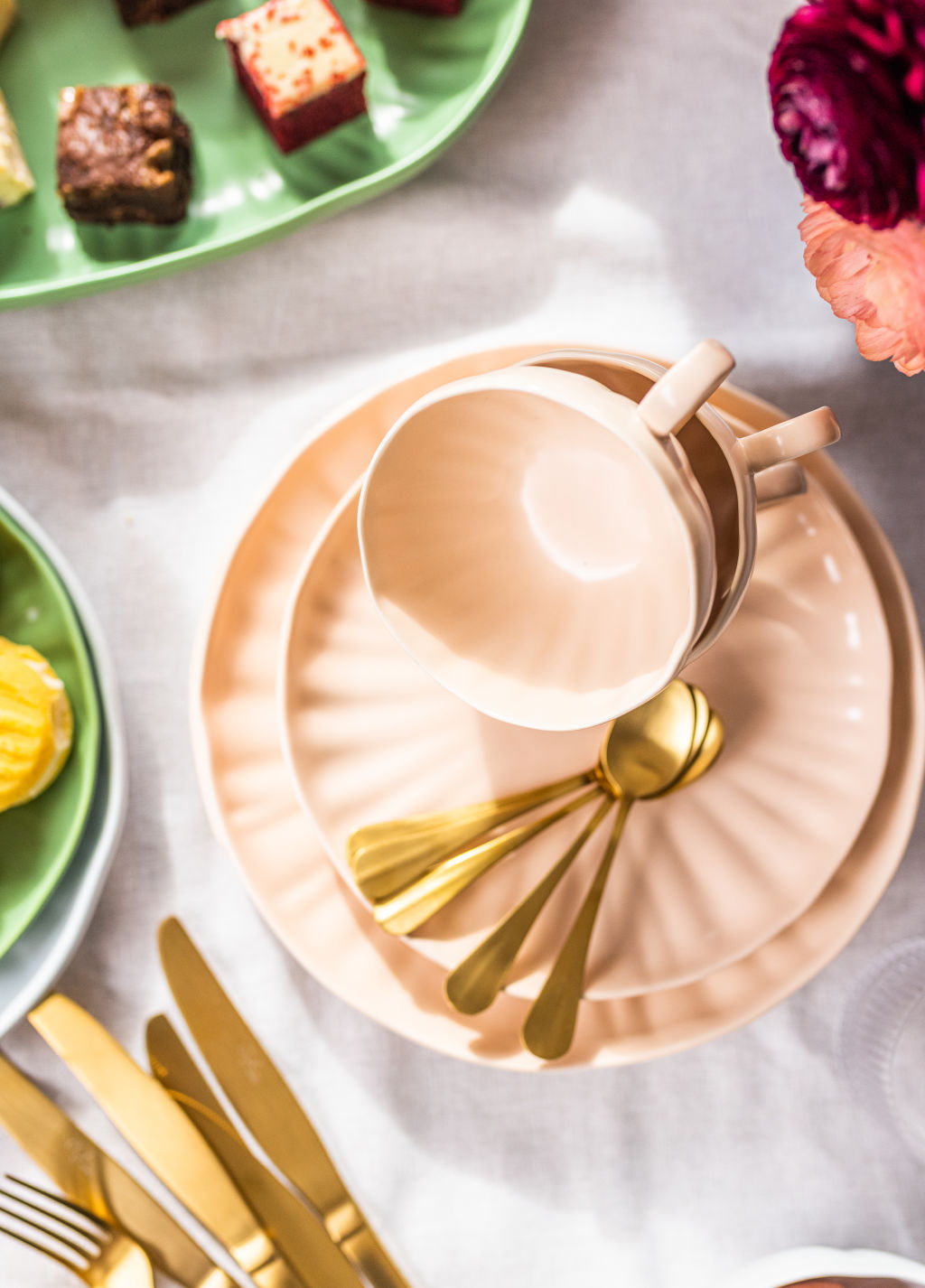 Chyka Keebaugh's homewares range features champagne-gold and matt-copper cutlery sets and peachy-pink linen napkins and place mats. Photo: Supplied.