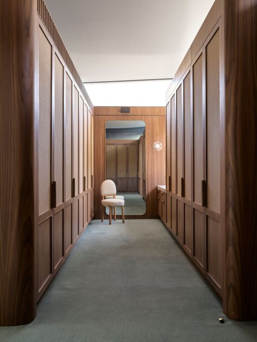 The empanelled wardrobe corridor, also in walnut and rattan. Photo: Anson Smart