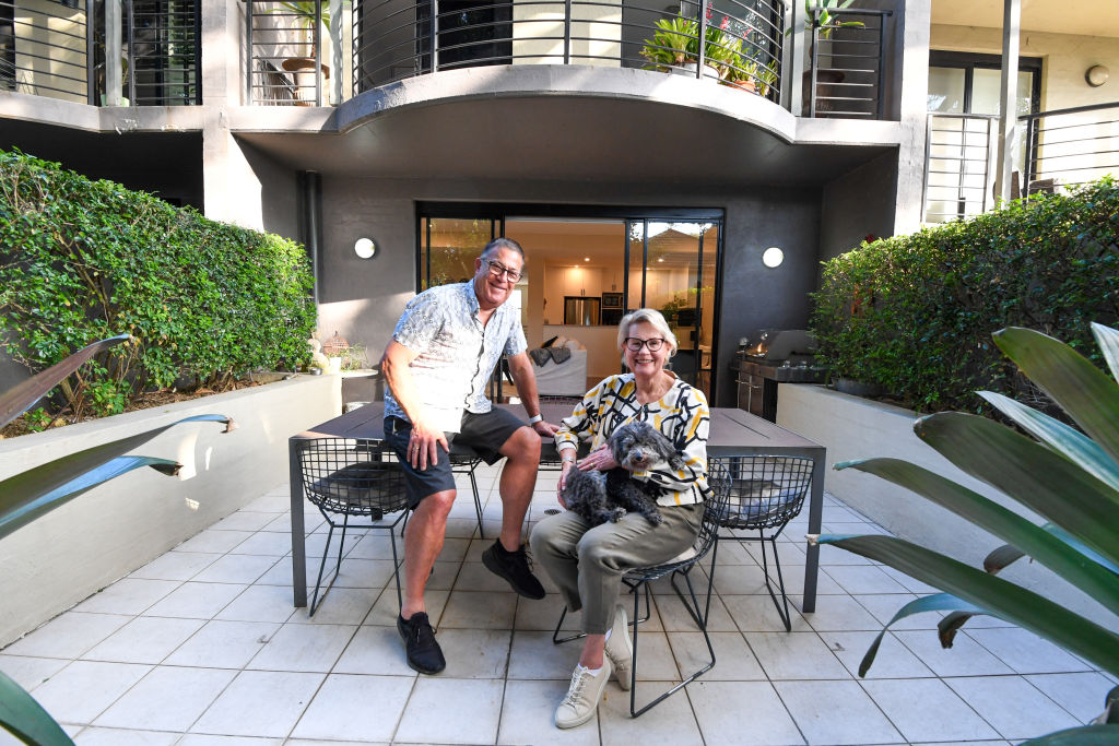 Downsizers Rowan and Jan Davies, pictured with dog Maggie, are among those hitting the market, having listed their three-bedroom home in Glebe. Photo: Peter Rae