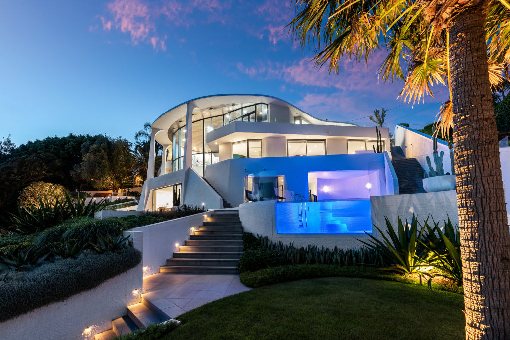 Built by Reuben Lane, the use of curves came to define the home that enjoys pristine water views. Photo: Supplied