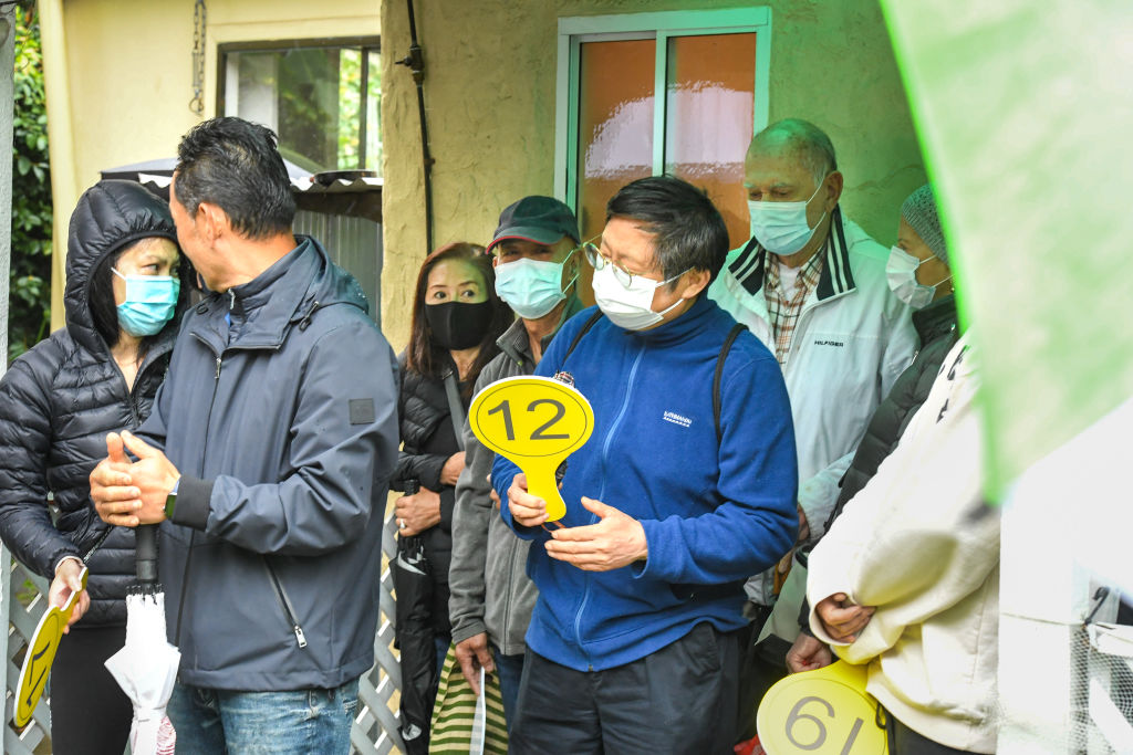 The rain did not deter bidders on Saturday as nine registered and four were active at the auction of a run-down terrace in Glebe. Photo: Peter Rae