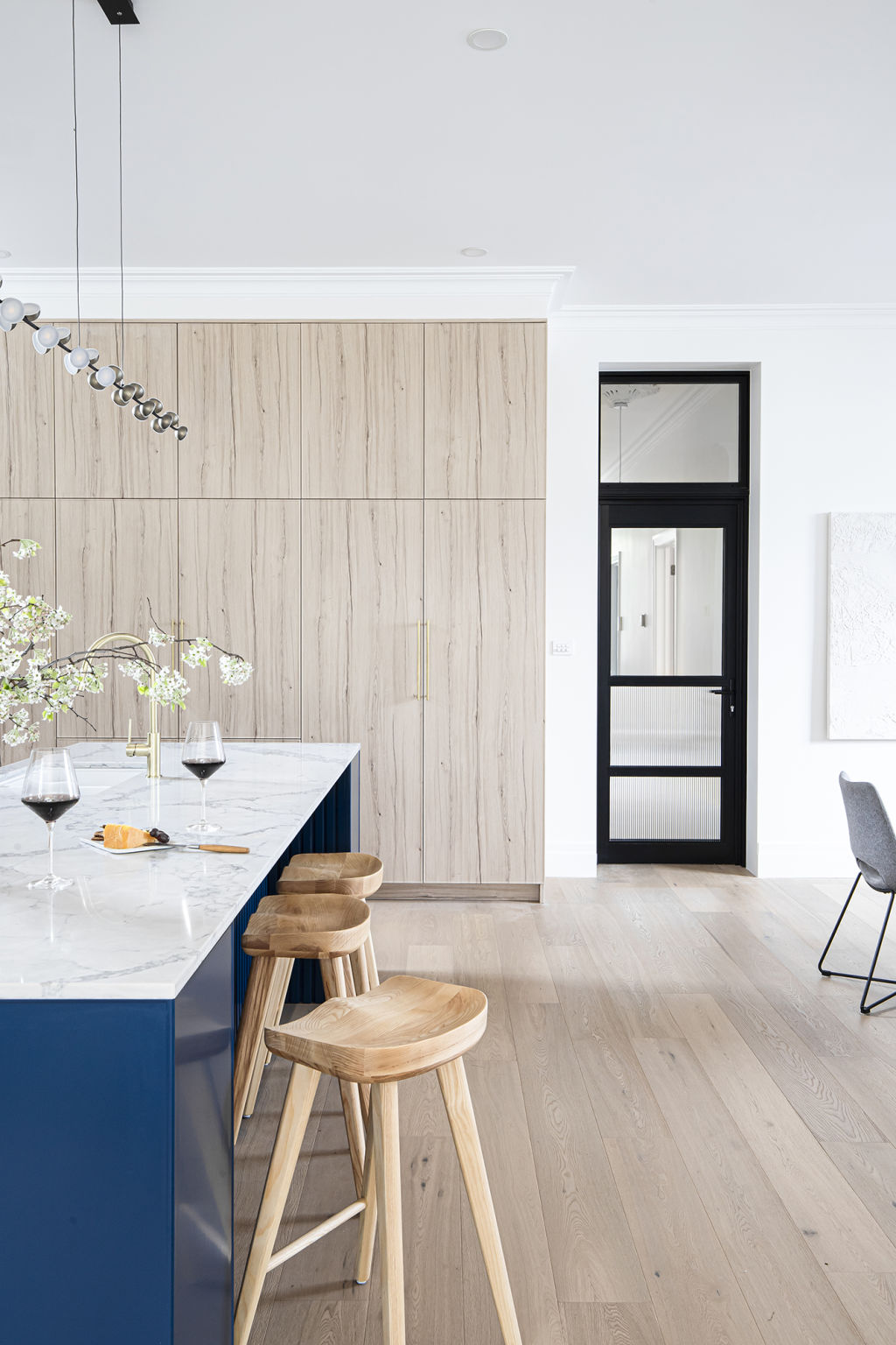 Neale recommends aluminium or steel doors with glass that provide a sound barrier while still allowing light through. Kitchen by M.J. Harris Group. Photo: Supplied