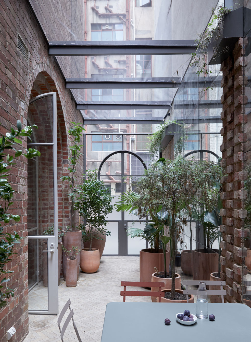 The garden atrium wraps around the interior which helps reduce the noise levels inside. Photo: James Geer, styling by Bek Sheppard