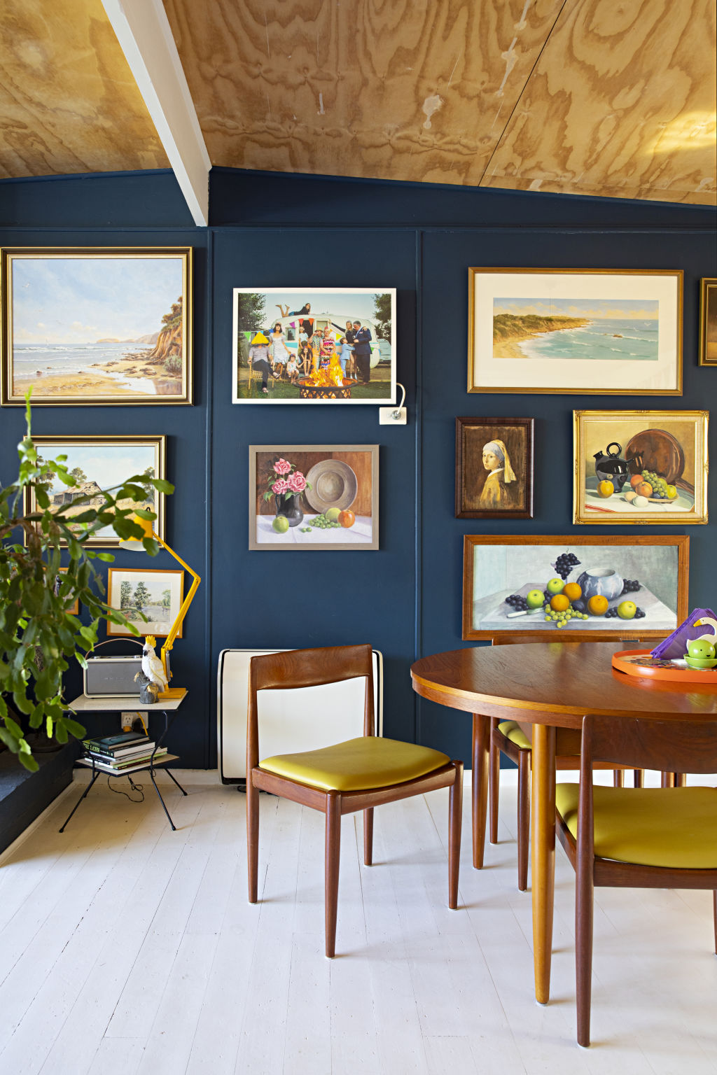 Price created a midnight-blue gallery wall featuring artworks painted by her late father. Photo: NATALIE JEFFCOTT