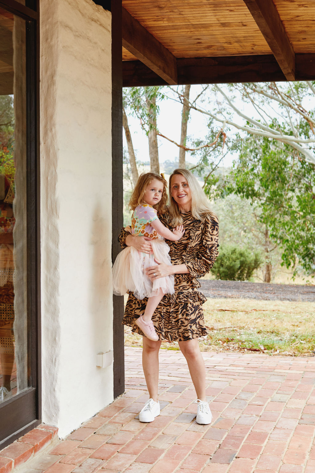 Susie Silverii with daughter Lulu on their 20-acre property built by Alistair Knox. Photo: Amelia Stanwix