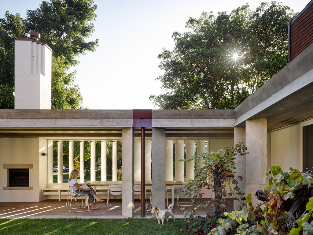 In the outdoor area, large timber louvres peer out to the street and are tilted for privacy or tweaked open for neighbourhood chats. Photo: Christopher Frederick Jones