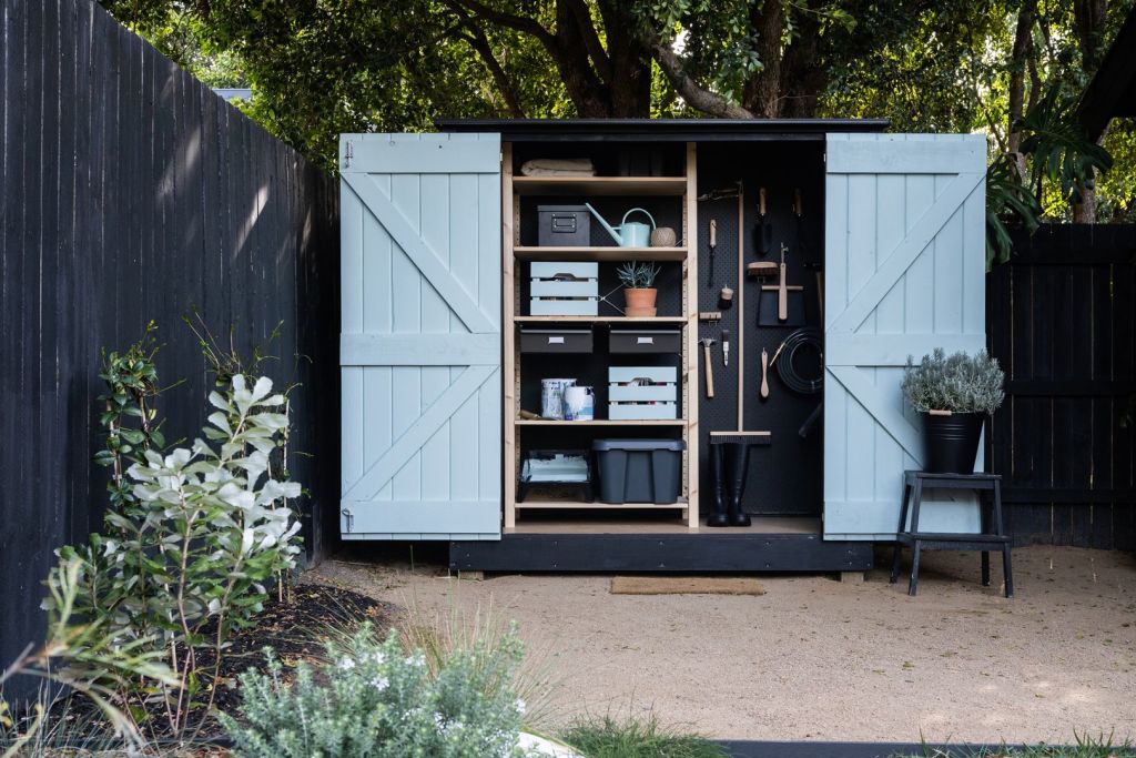 Parker customised the tool shed by painting the internal doors blue, the exterior black, and adding a pegboard wall. Photo: Coast Park Creative
