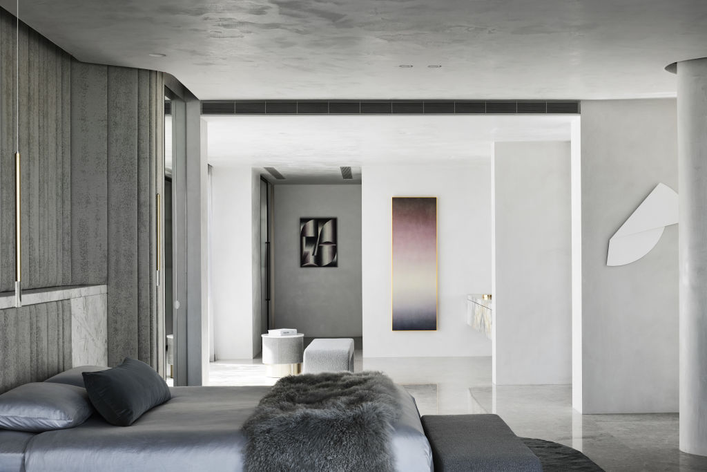 In the main bedroom, a customised wall is crafted from cushioning and stone. Foreground artwork by Anna Dudek; middle artwork by Rosie Mudge; background artwork by Florian and Michael Quistrebert. Photo: SHARYN CAIRNS PHOTOGRAPHY