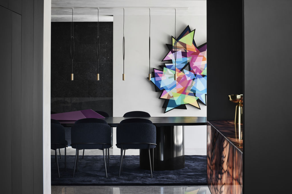 An extraordinary spraypainted artwork by artist Andrzej Urbanski creates drama in the dining room. Geometric artwork by Andrzej Urbanski. Table sculpture by Anna Dudek. Photo: SHARYN CAIRNS PHOTOGRAPHY