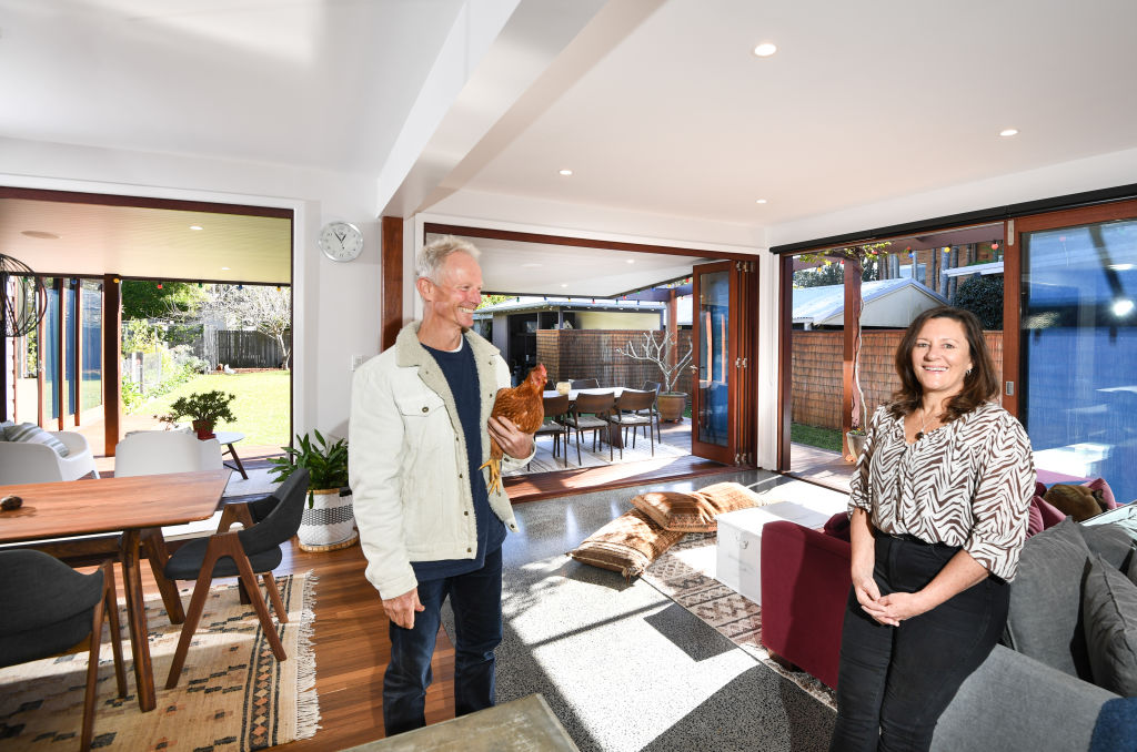 Rod and Kazz Powell in their home at Avalon Beach, Sydney, which is 'just beautiful to live in' thanks to its sustainable design incorporating passive design elements. Pictured behind them is the concrete floor being naturally warmed by the sun, eliminating the need for heating. Photo: Peter Rae