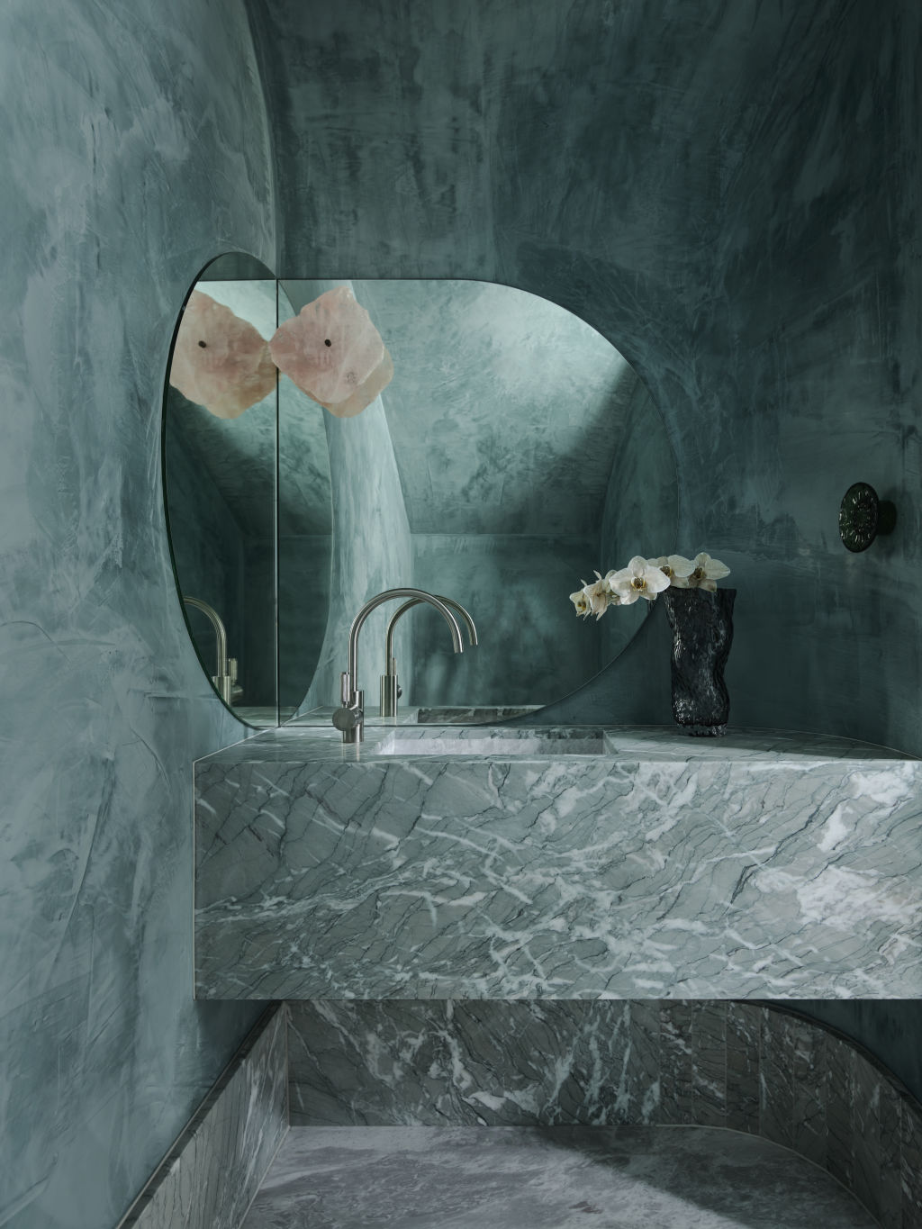 Tucked beneath the staircase is the stunning, jewel-like powder room. Styling: Claire Del Mar. Photo: Anson Smart