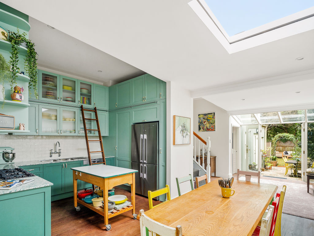 The timber cabinetry in the designer kitchen comes in two shades of green. Photo: Supplied