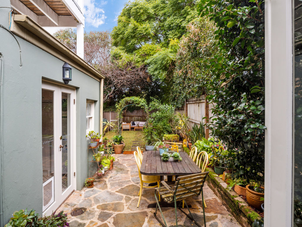 The paved dining terrace leads onto the garden. Photo: Supplied