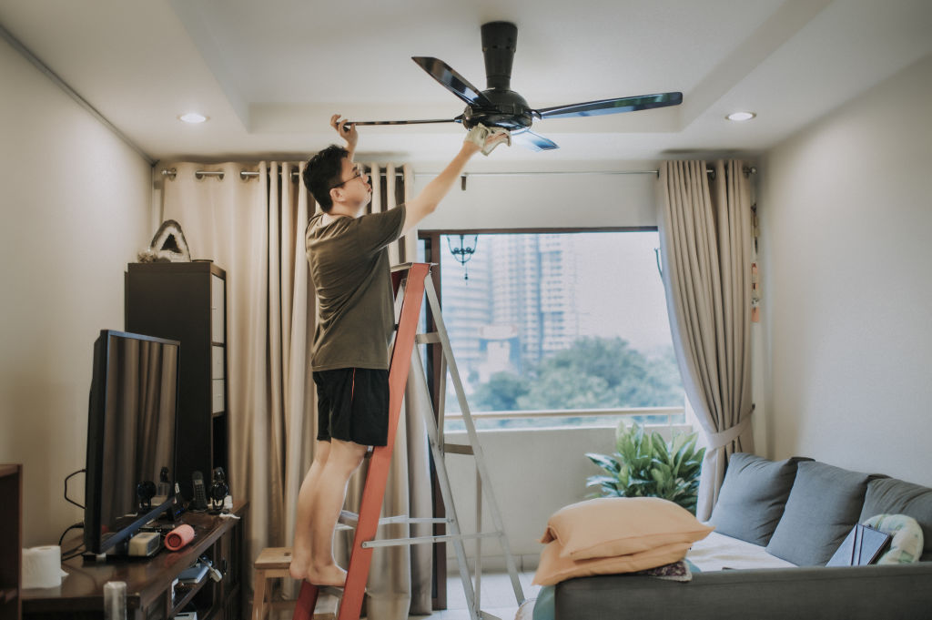 Instead of using a duster or cloth, try cleaning the ceiling fan with a pillowcase instead. Photo: Edwin Tan