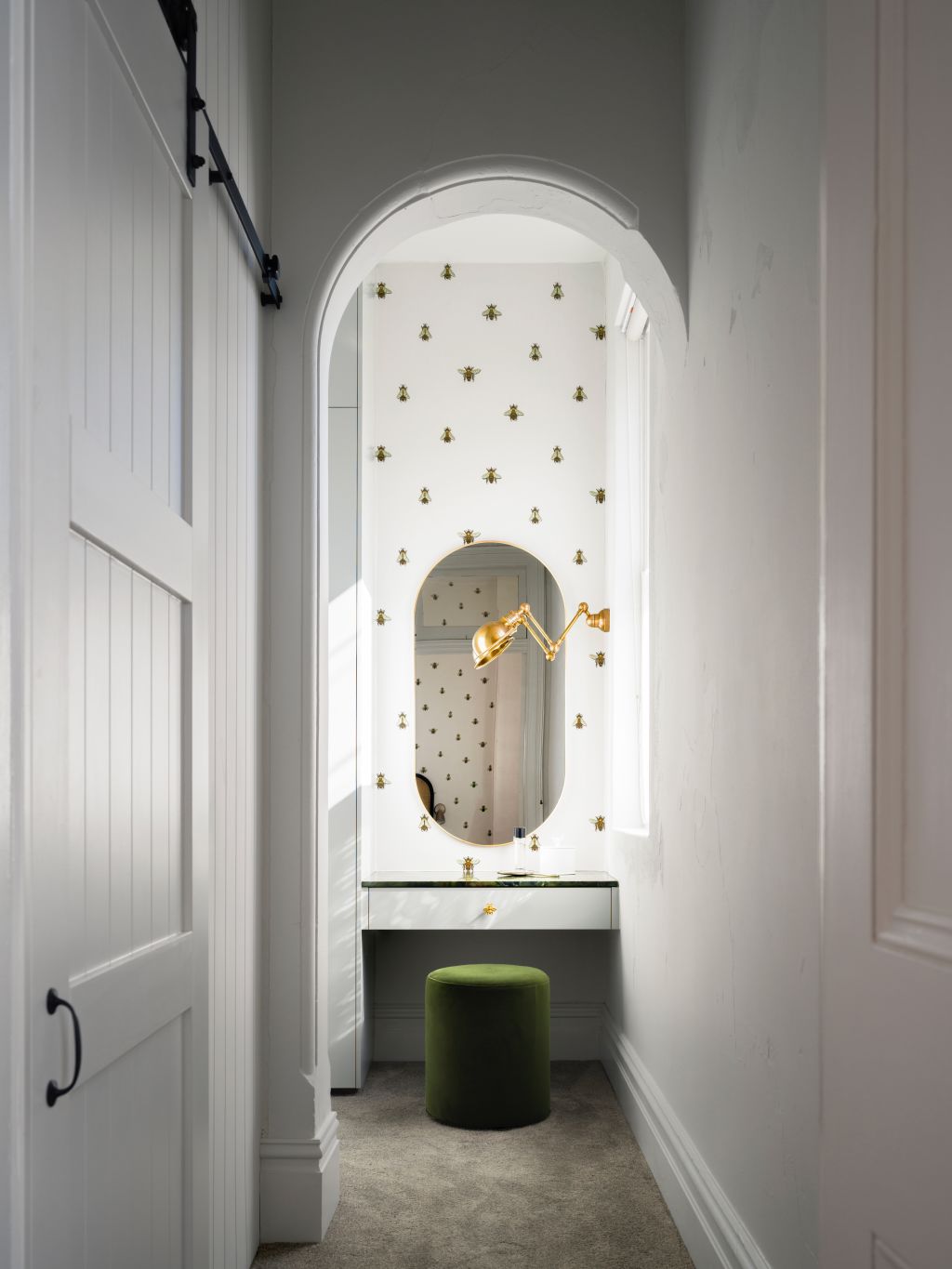 Next to the outdoor vegetable garden and bee hive is the 'Bee Room', a small bee-embossed wallpaper-wrapped space that acts as a dressing room. Photo: Justin Alexander