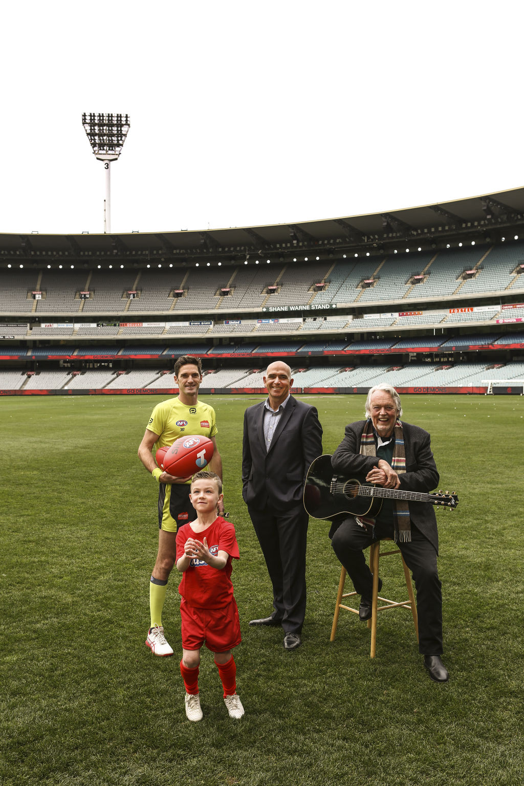 Footy's back at the MCG. MCC CEO Stuart Fox, Aus Kicker Harry Austin, Umpire Matt Stevic, Musician Mike Brady. Photo: Julian Kingma