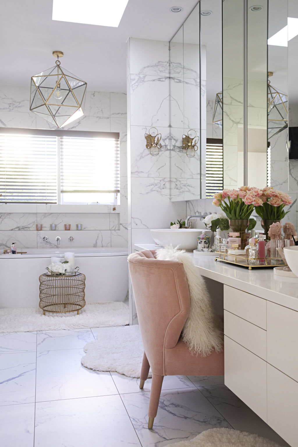 All bathrooms are covered in floor-to-ceiling calacatta marble tiles to dial in a classic mood. Photo: Natalie Jeffcott