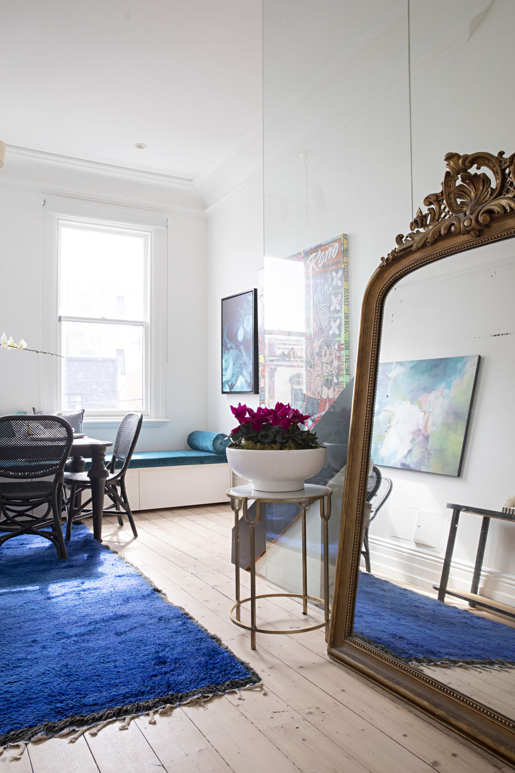 Crisp white walls and pale timber flooring are the perfect backdrop for oversized artwork dotted around the home. Photo: Natalie Jeffcott