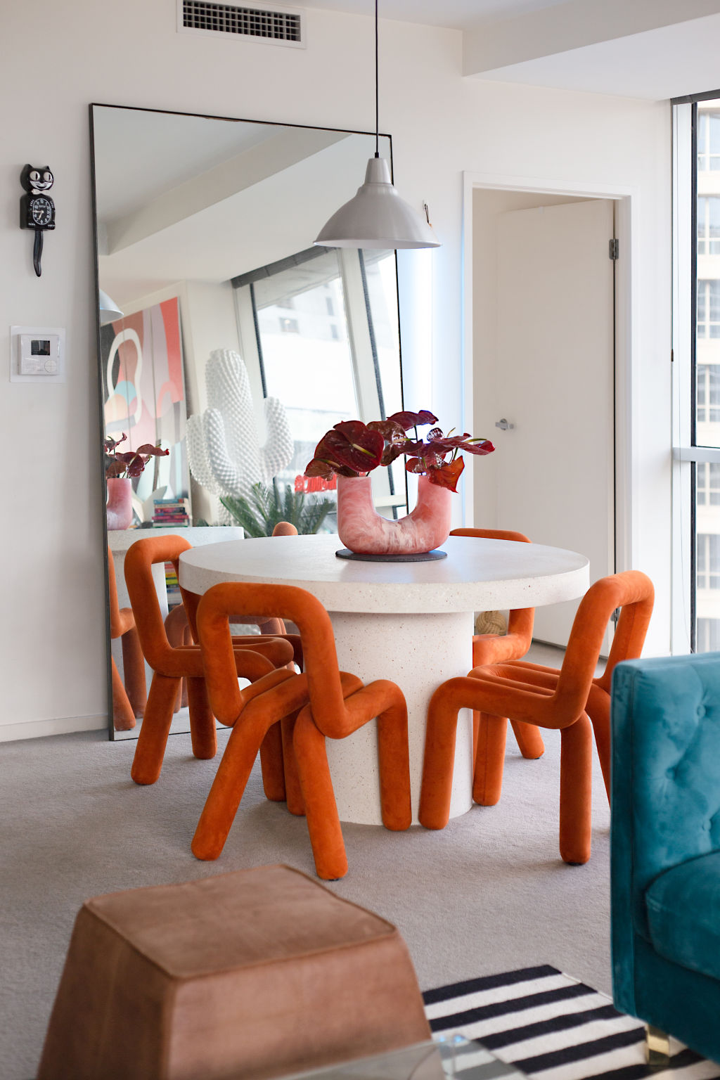 Splurge items include replica Bold Chairs made from steel and sponge, and a Coco Republic dining table. Photo: Emma Byrnes