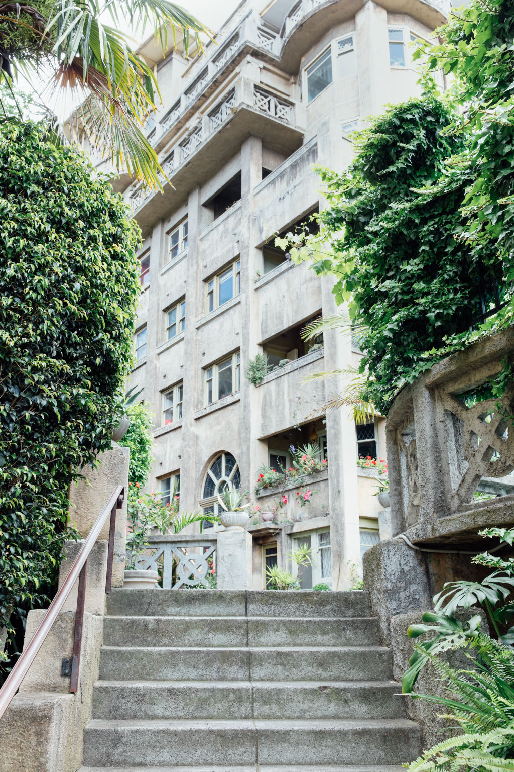 Built in 1935-1936, the Beverley Hills flats is a Spanish mission-style complex in South Yarra spanning two buildings set around a central pool with tropical landscaping. Photo: Emma Byrnes