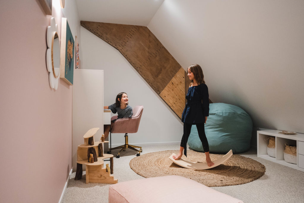 Two second-storey loft spaces give daughters Olivia and Ivy plenty of space to play. Photo: HANNAH PUECHMARIN