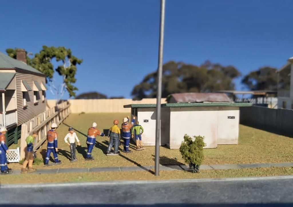 Donnelly sets the scene for his model buildings, having also constructed a model streetscape complete with miniature versions of builders, construction workers and other townsfolk. Photo: Supplied