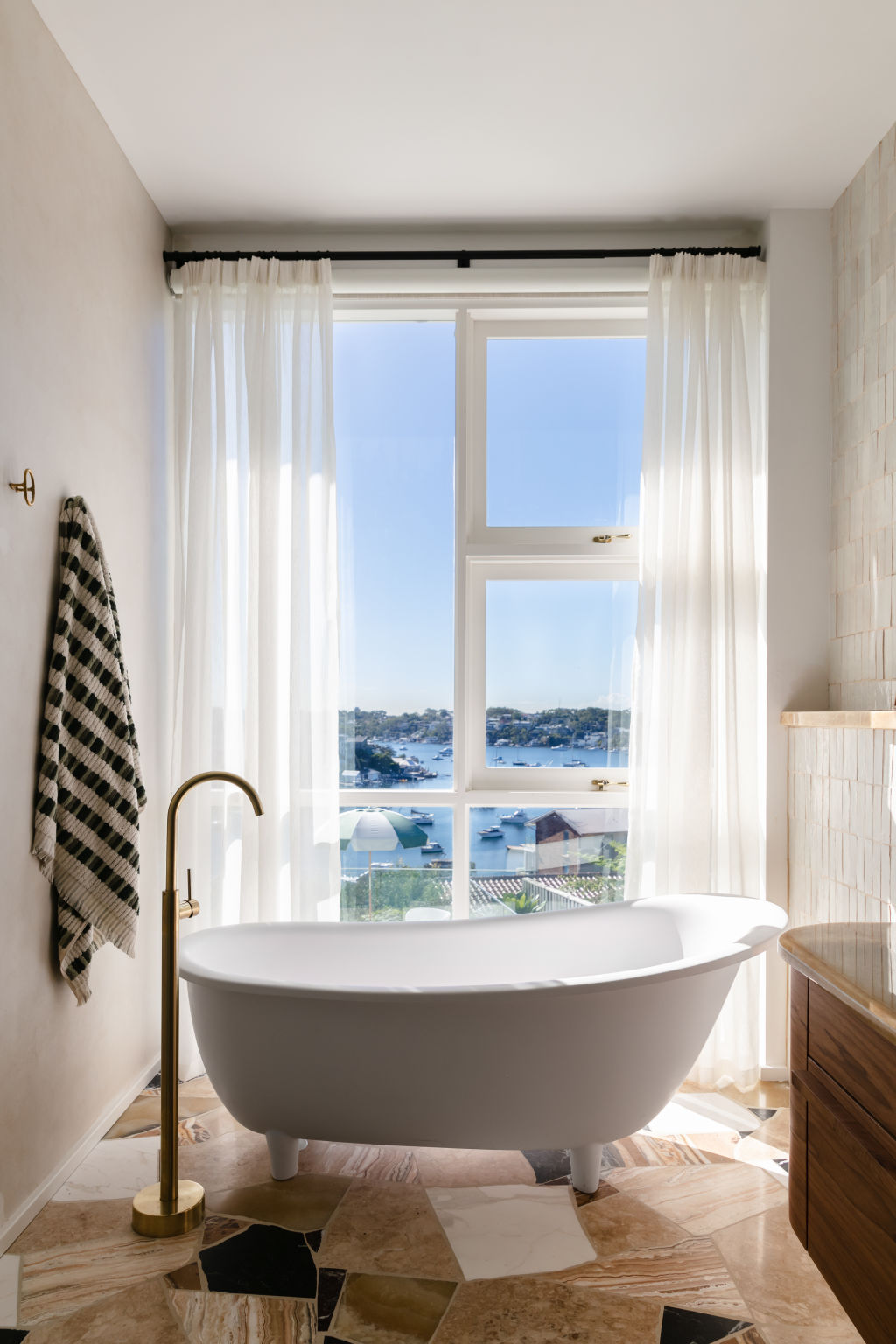 The Palladiana-style marble-offcut flooring stars in Jones’ en suite, and so does that view. Photo: Trudy Pagden