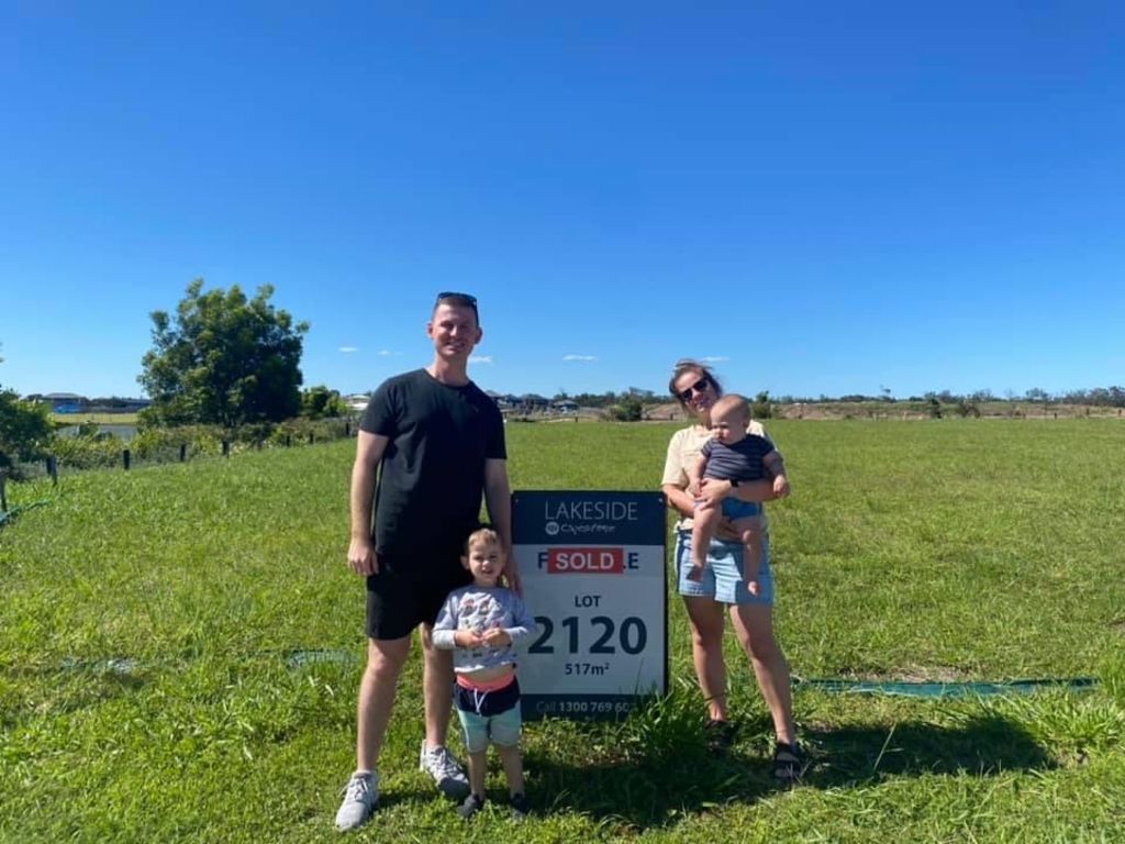 The Collins family with their children Callan (left) and Marcus, at their block of land before the house started. Photo: Supplied