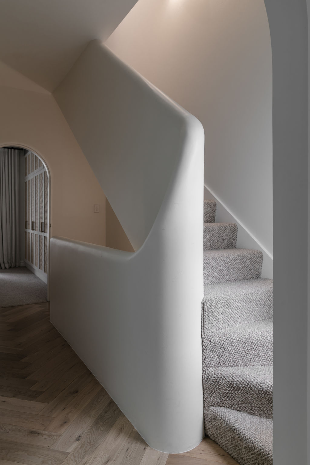 They got rid of the rickety old staircase and replaced it with a Mediterranean-style curved plaster one. Photo: Trudy Pagden
