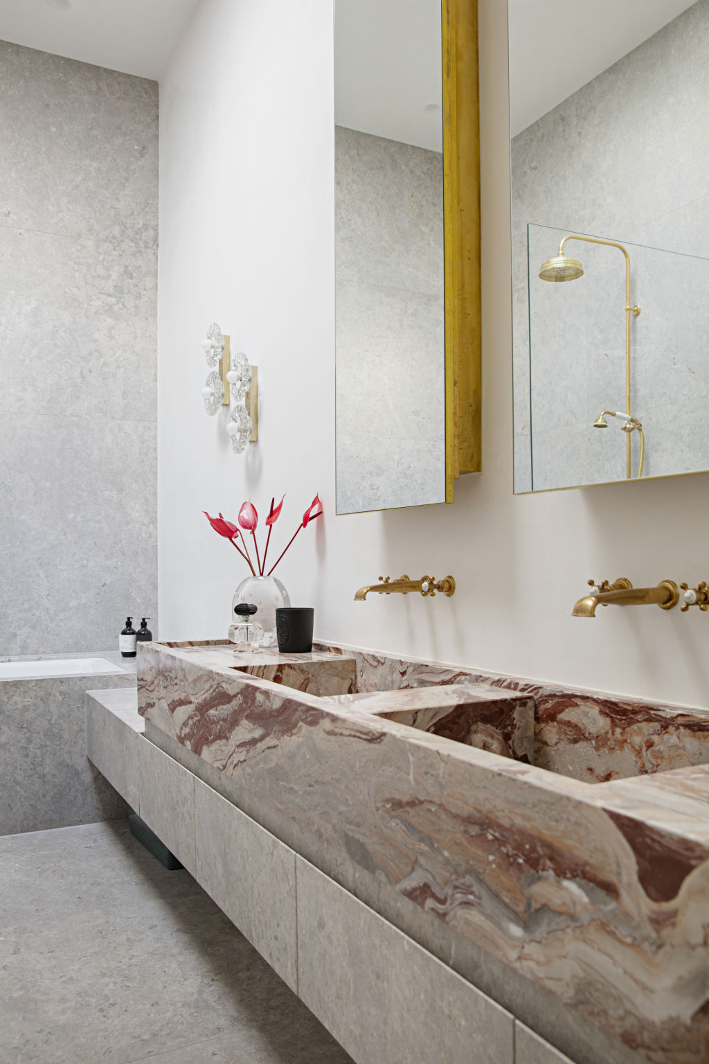 The bathrooms are swathed in swirling Italian rosso and grigio marble. Photo: Natalie Jeffcott