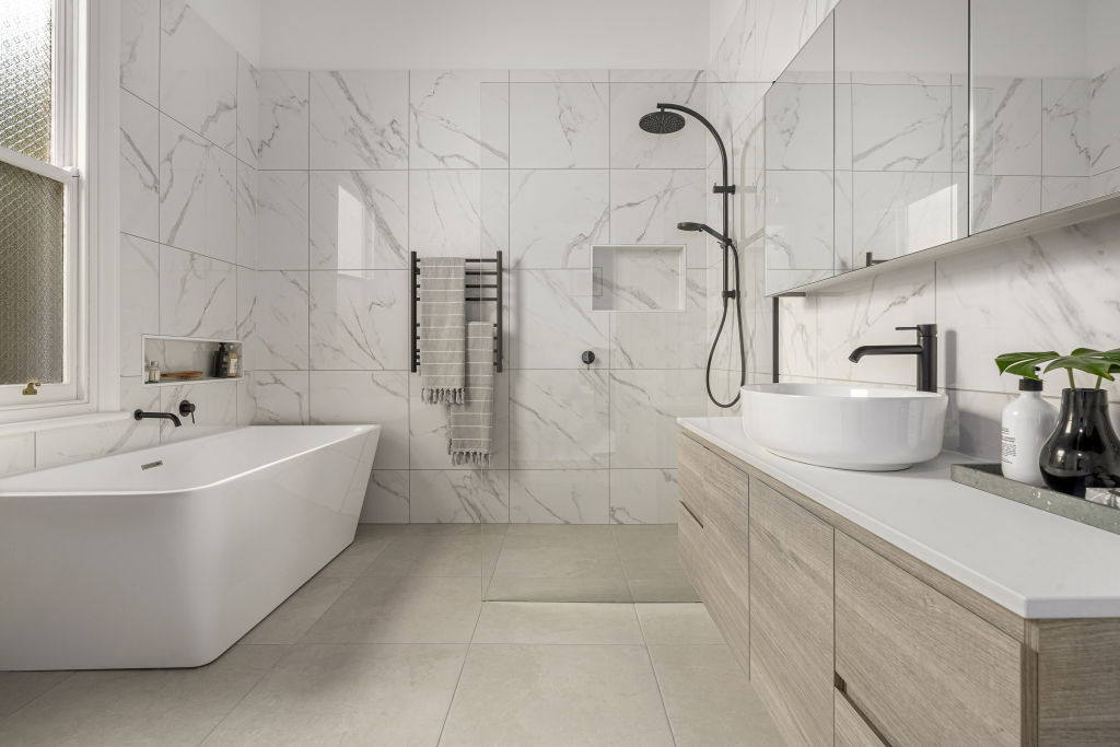 Luxury additions can include custom shower niches, under-tile heating and bespoke cabinetry. Photo: Belle