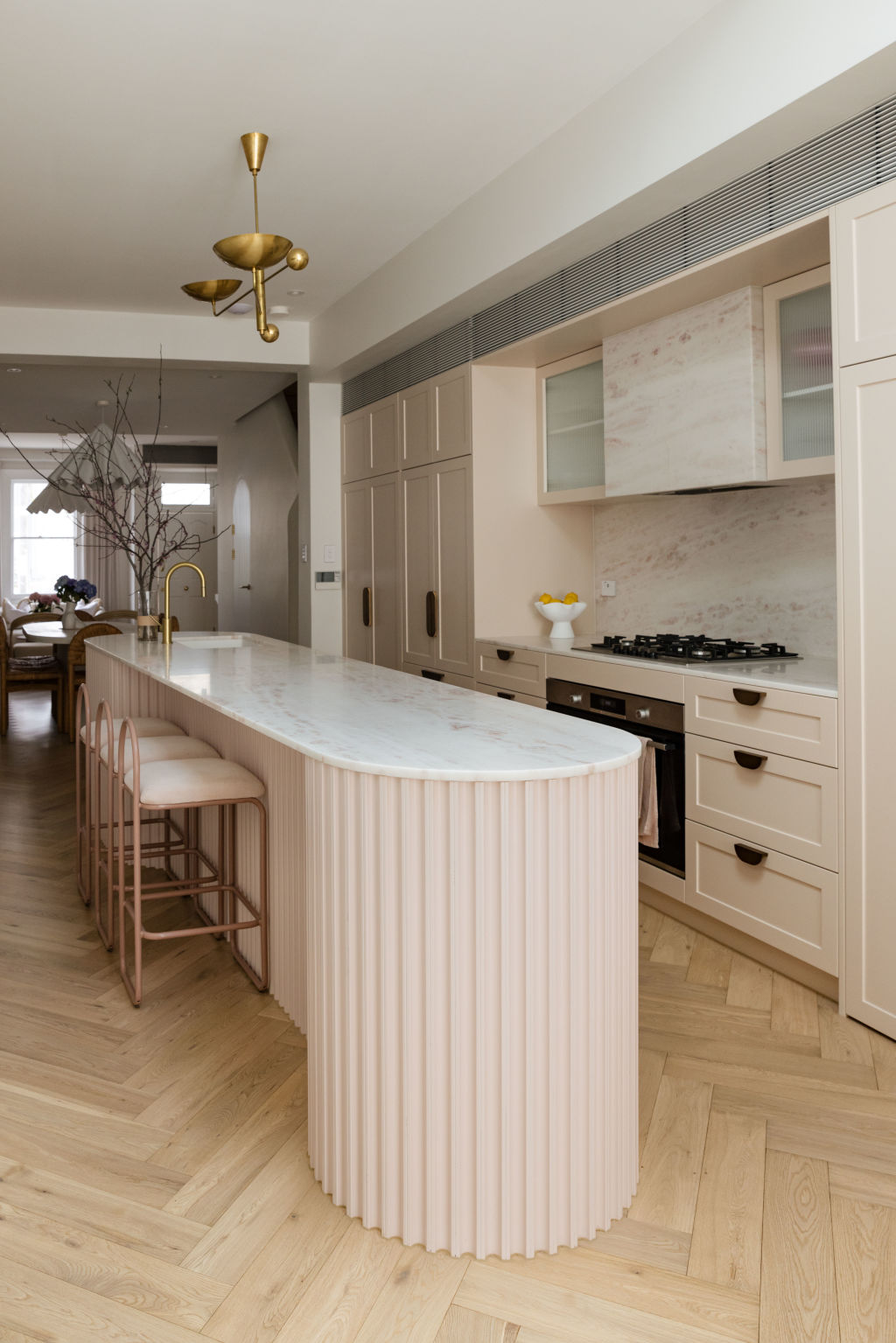 The undisputed star of the home is the playfully curvaceous and perfectly pink, marble-swathed kitchen. Photo: Supplied